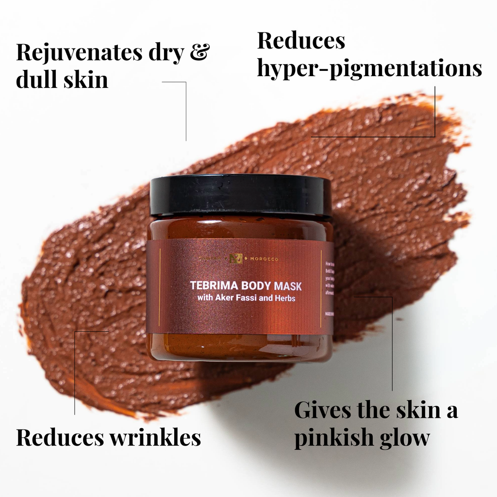 Zawina Morocco Tebrima Body Mask with Aker Fassi and Herbs jar over a reddish-brown paste swatch, highlighting benefits: rejuvenates dry & dull skin, reduces hyper-pigmentations, reduces wrinkles, and gives the skin a pinkish glow