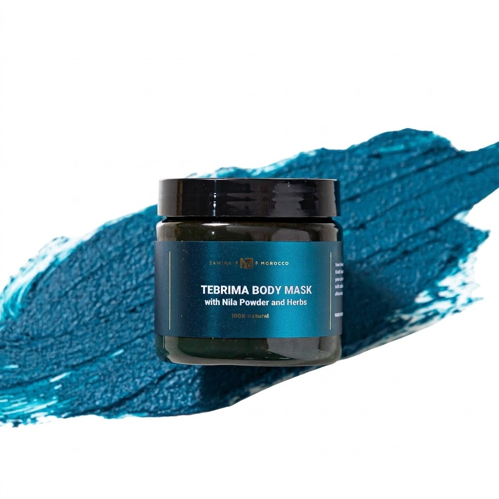 Zawina Morocco Tebrima Body Mask with Nila Powder and Herbs jar resting over a swatch of rich deep teal blue mask paste